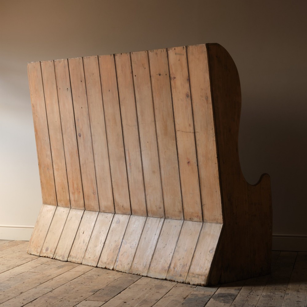 An early nineteenth-century Georgian pine high-backed settle featuring winged side panels and a planked box base. View XIII