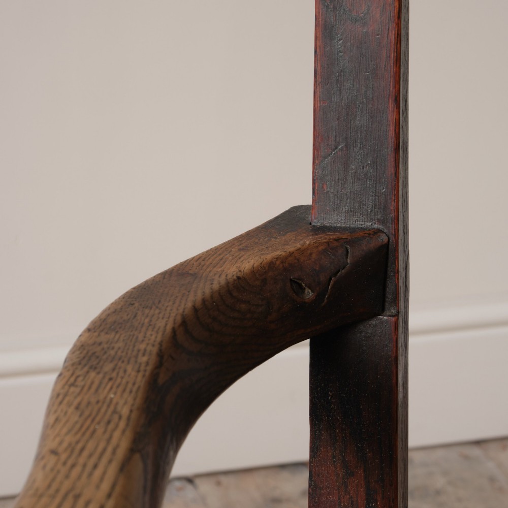 A Georgian oak open armchair featuring a vase-shaped splat back, solid seat, shaped armrests, and an H-stretcher base. View IV