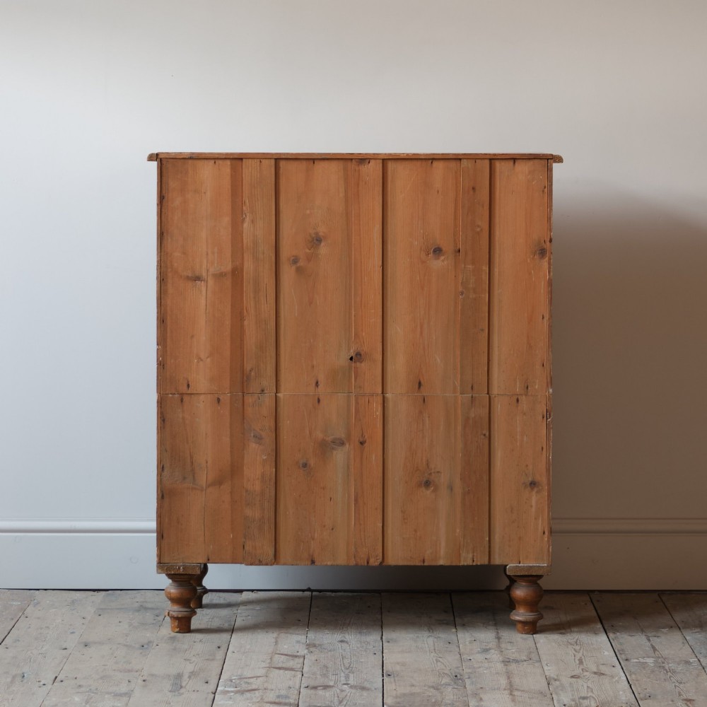 A Victorian 19th-century pine chest of drawers with a scumble painted finish, featuring two short over three long drawers with turned wooden knobs. View V