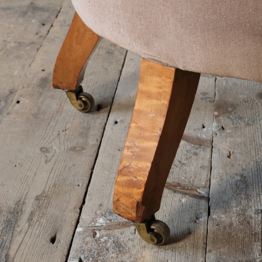 A mid-19th-century button-backed armchair upholstered in taupe velvet with turned timber front legs resting on brass castors. View XI