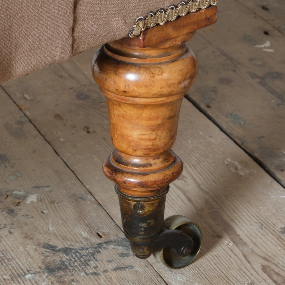 A mid-19th-century button-backed armchair upholstered in taupe velvet with turned timber front legs resting on brass castors. View XII
