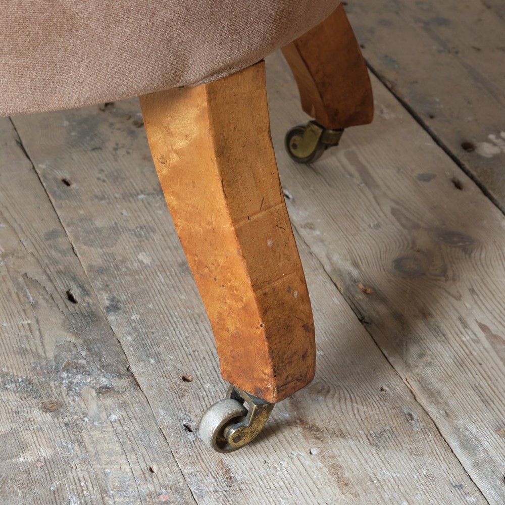 A mid-19th-century button-backed armchair upholstered in taupe velvet with turned timber front legs resting on brass castors. View XIII