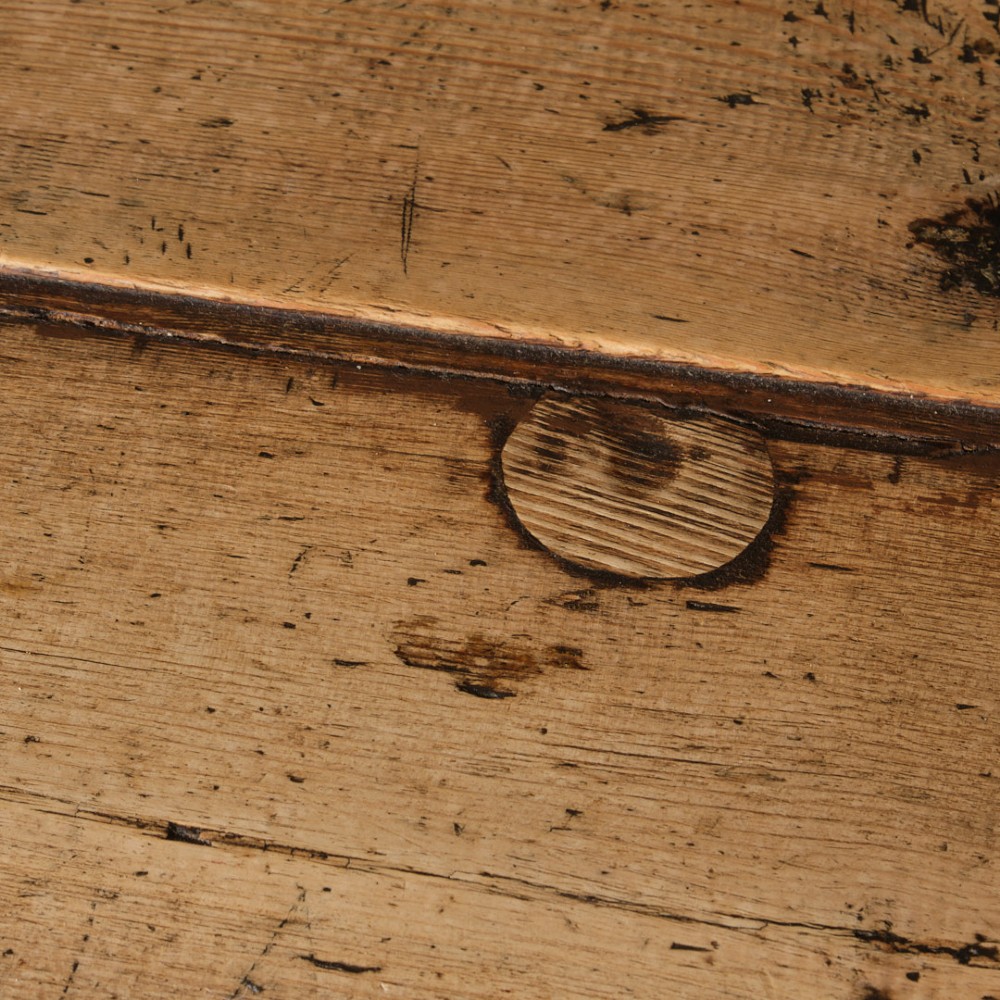 A long antique pine workbench table featuring a heavy plank top supported by a sturdy timber frame with X-frame cross bracing. View IV