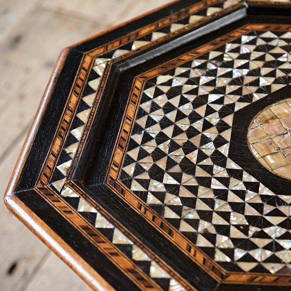 An octagonal dark ebonised wood Moorish side table featuring geometric mother-of-pearl inlay and pointed arch cut-outs along the base. View VI