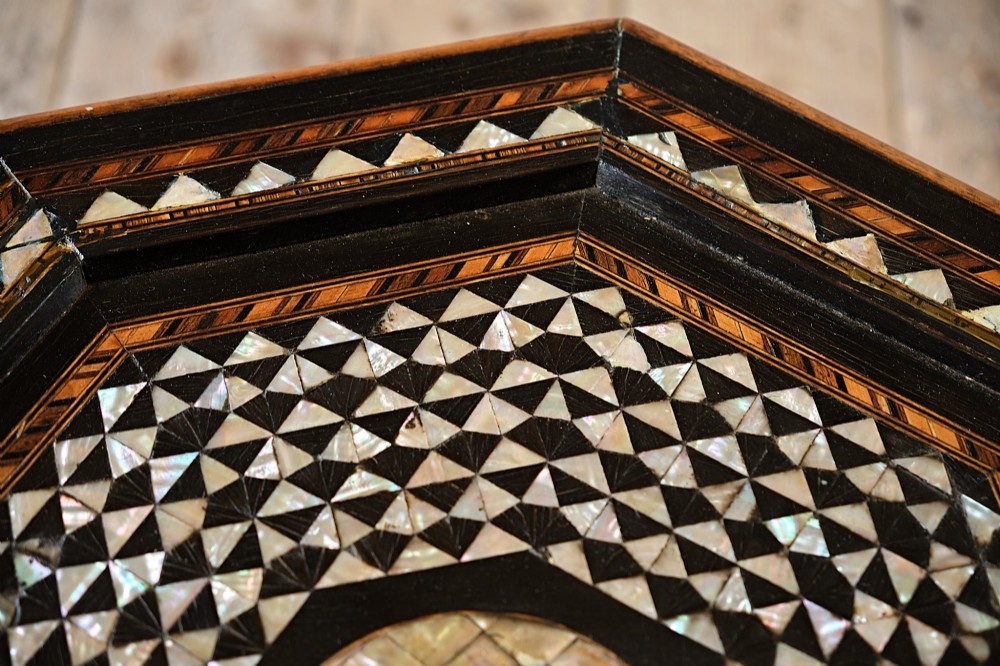 An octagonal dark ebonised wood Moorish side table featuring geometric mother-of-pearl inlay and pointed arch cut-outs along the base. View VII