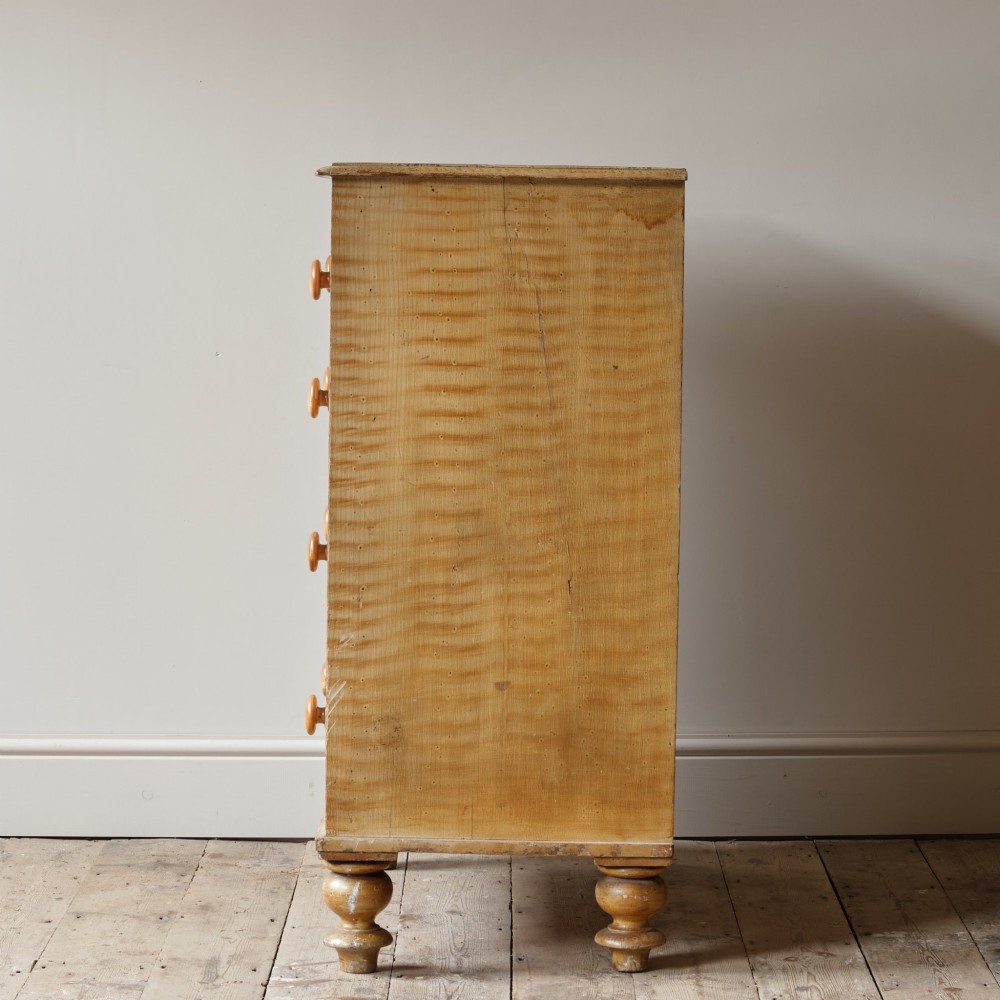 A mid-nineteenth-century pine chest of drawers featuring a faux-grain painted finish, turned wooden knobs, two short drawers over three long drawers, and turned feet. View III