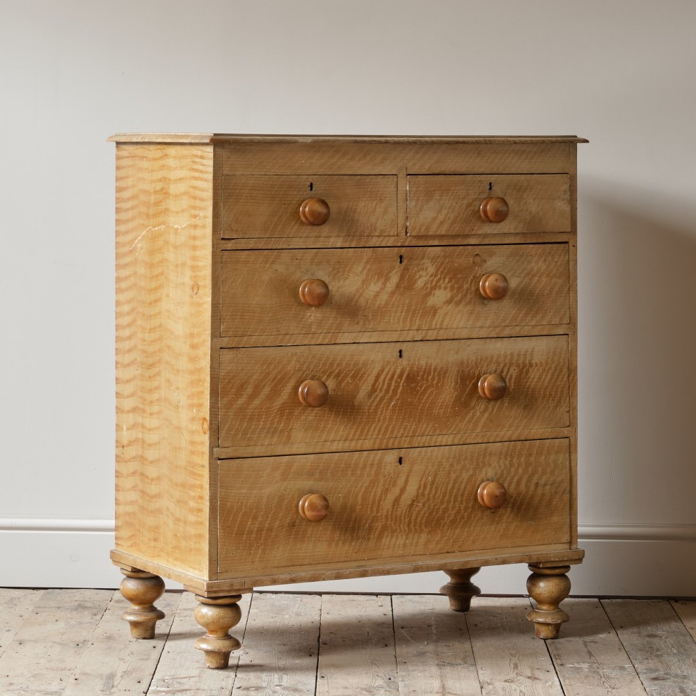 A mid-nineteenth-century pine chest of drawers featuring a faux-grain painted finish, turned wooden knobs, two short drawers over three long drawers, and turned feet. View VI