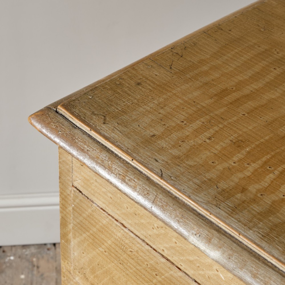 A mid-nineteenth-century pine chest of drawers featuring a faux-grain painted finish, turned wooden knobs, two short drawers over three long drawers, and turned feet. View IX