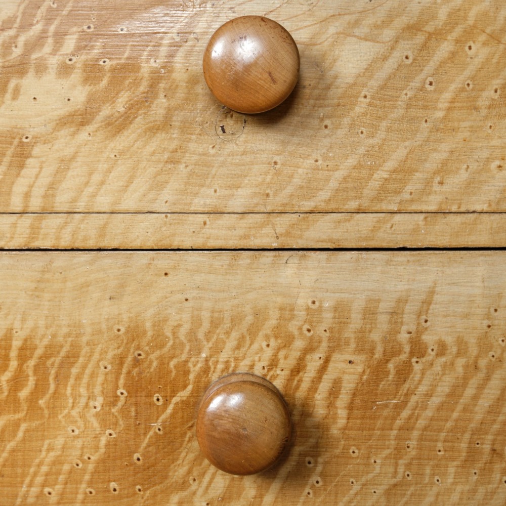 A mid-nineteenth-century pine chest of drawers featuring a faux-grain painted finish, turned wooden knobs, two short drawers over three long drawers, and turned feet. View XI