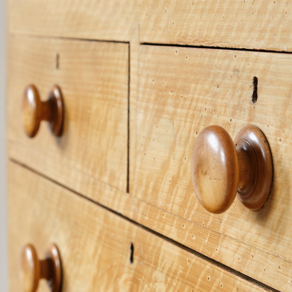 A mid-nineteenth-century pine chest of drawers featuring a faux-grain painted finish, turned wooden knobs, two short drawers over three long drawers, and turned feet. View XIII