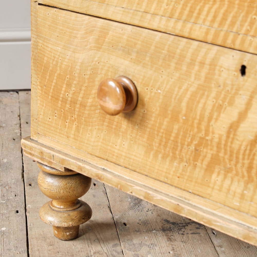 A mid-nineteenth-century pine chest of drawers featuring a faux-grain painted finish, turned wooden knobs, two short drawers over three long drawers, and turned feet. View XV