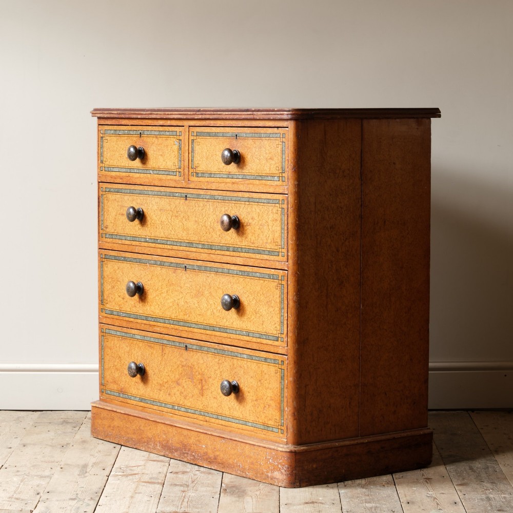 A 19th-century pine chest of drawers featuring an ochre painted finish with decorative green line borders, two short drawers over three long drawers, and turned wooden knobs. View III