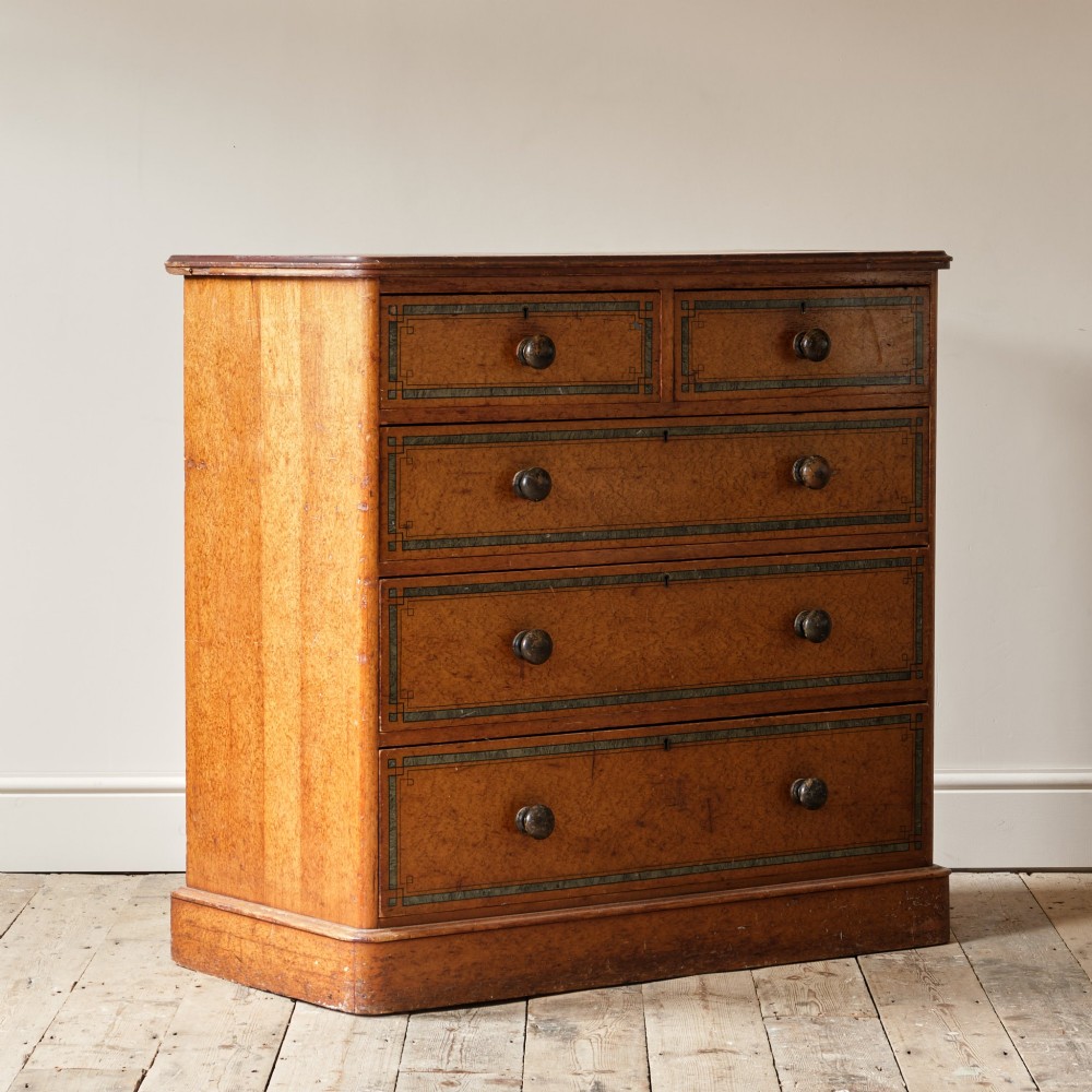 A 19th-century pine chest of drawers featuring an ochre painted finish with decorative green line borders, two short drawers over three long drawers, and turned wooden knobs. View VII