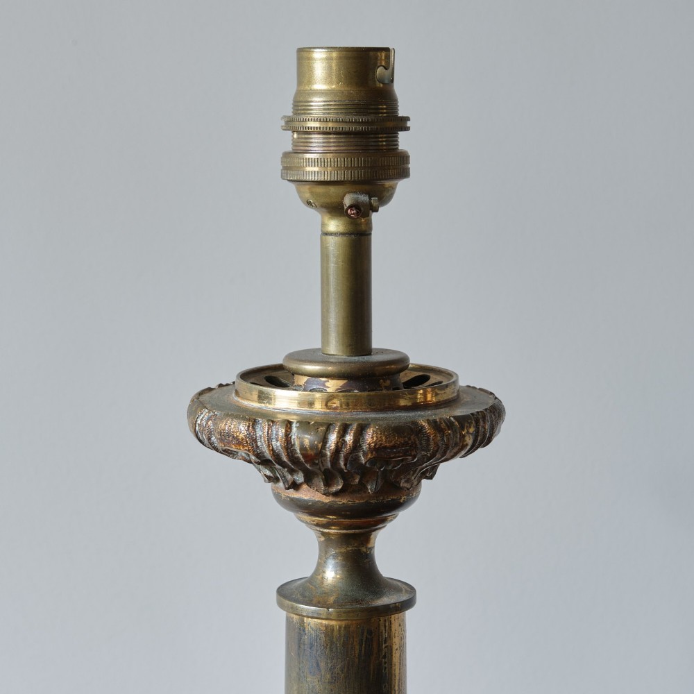 A 19th-century gilt brass table lamp base featuring a tapered central column, stylized foliage details, and an octagonal plinth base. View V