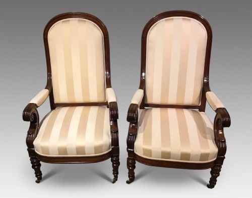 A PAIR OF ANTIQUE UPHOLSTERED ARMCHAIRS