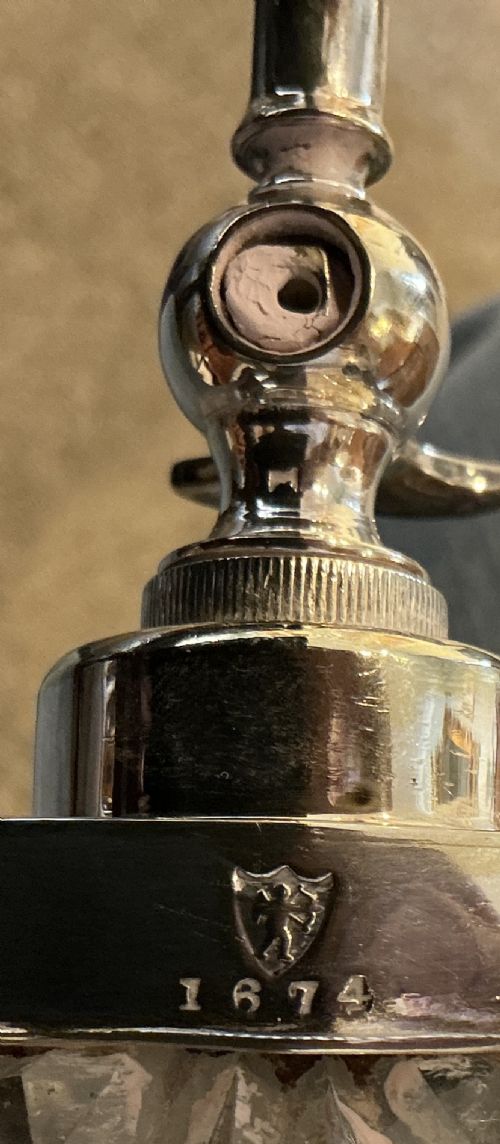 A Victorian cut crystal spirit barrel featuring geometric diamond patterns, silver-plated hoops, a metal tap, and a stopper, resting on a four-legged silvered stand. View V