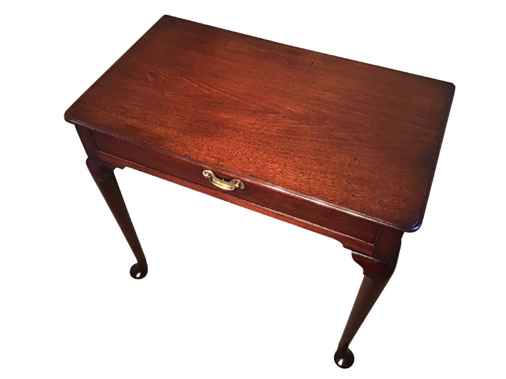 A Georgian mahogany side table featuring a single frieze drawer with a brass handle, supported by slender cabriole legs with pad feet. View II
