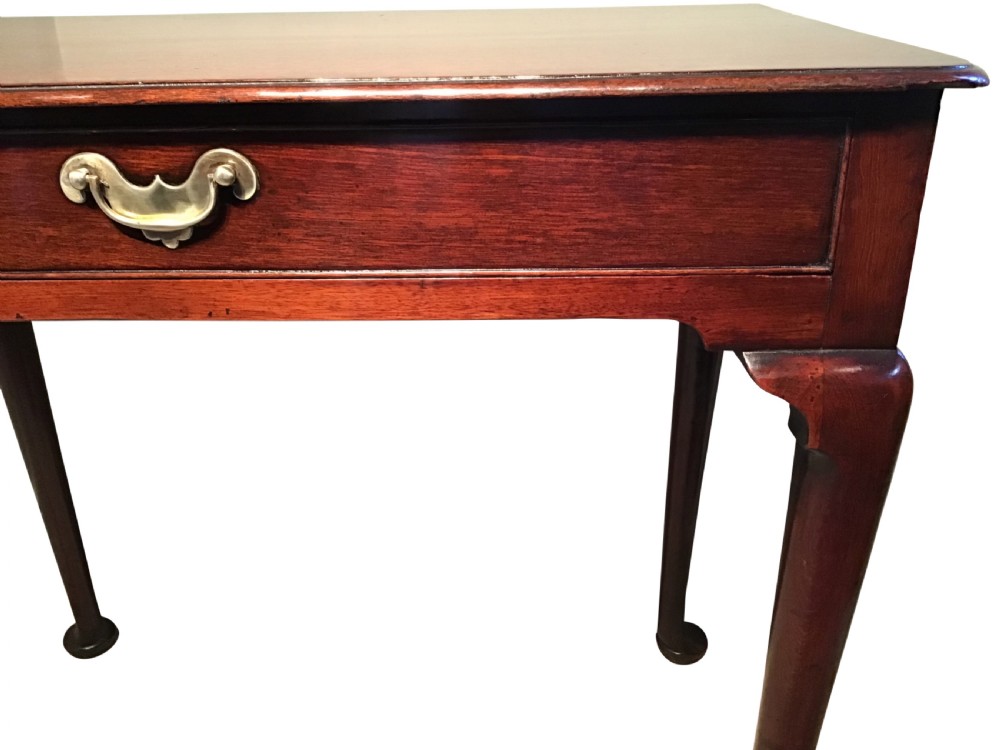 A Georgian mahogany side table featuring a single frieze drawer with a brass handle, supported by slender cabriole legs with pad feet. View IV