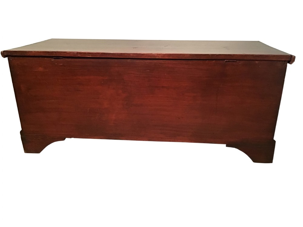 A low rectangular antique painted pine coffer featuring a hinged top lid, brass keyhole escutcheon, and bracket feet. View IV
