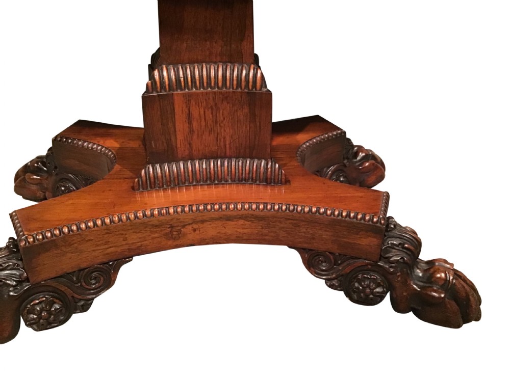 A William IV rosewood fold-over card table featuring a rectangular top with rounded corners, gadrooned edging, a central pedestal stem, and a carved quadform base resting on paw feet. View II