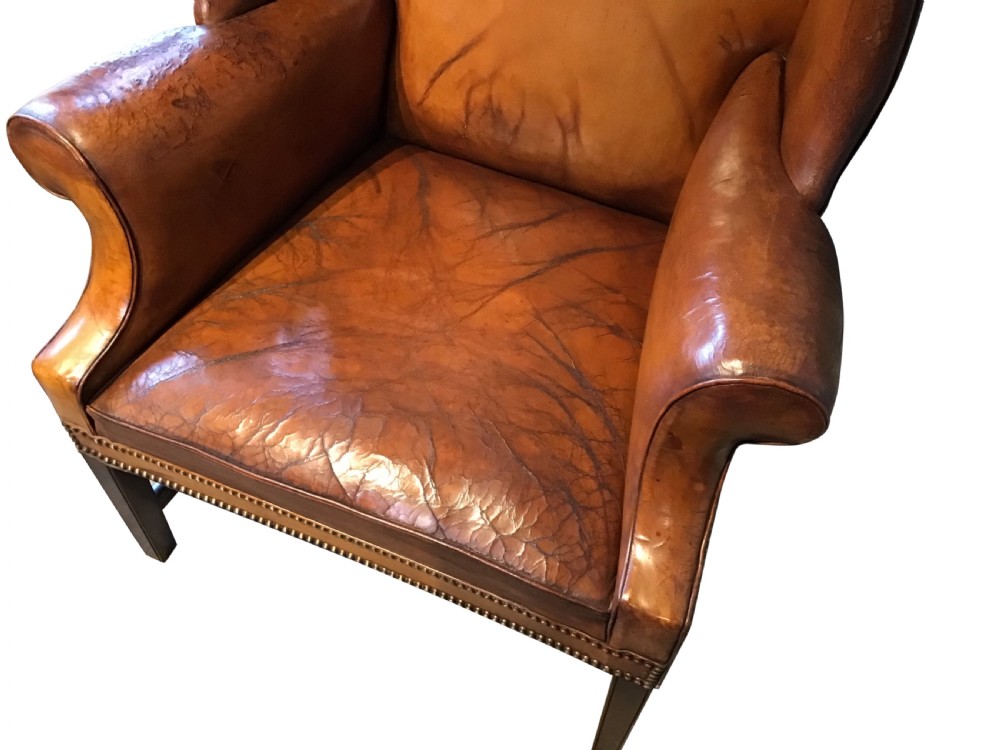Antique leather upholstered wing chair View V