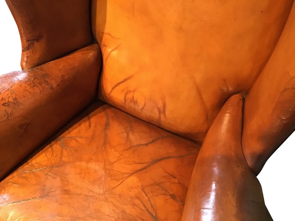 Antique leather upholstered wing chair View VI
