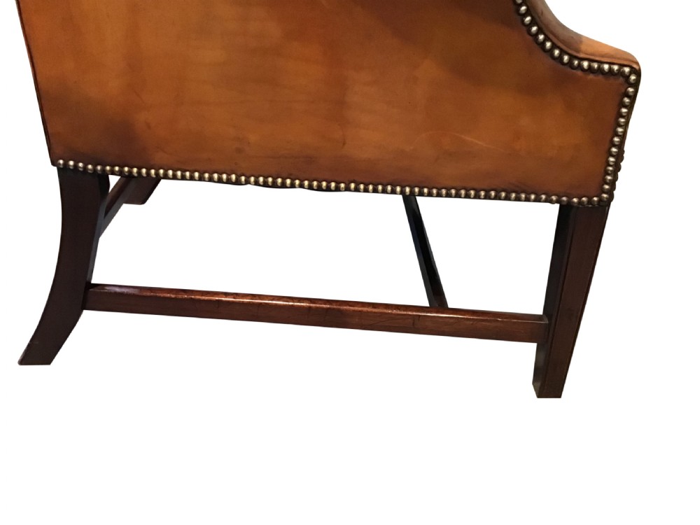Antique leather upholstered wing chair View VII