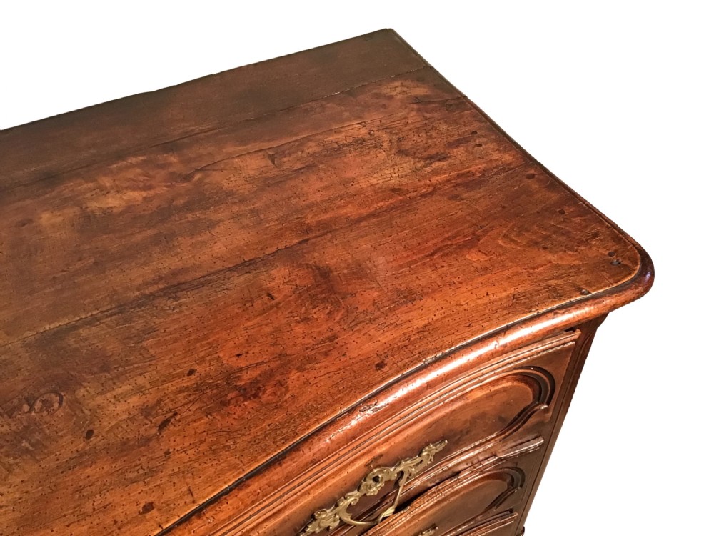 An antique French Louis XV style walnut commode featuring three contoured drawers with moulded panels and ornamental brass handles on cabriole legs. View III