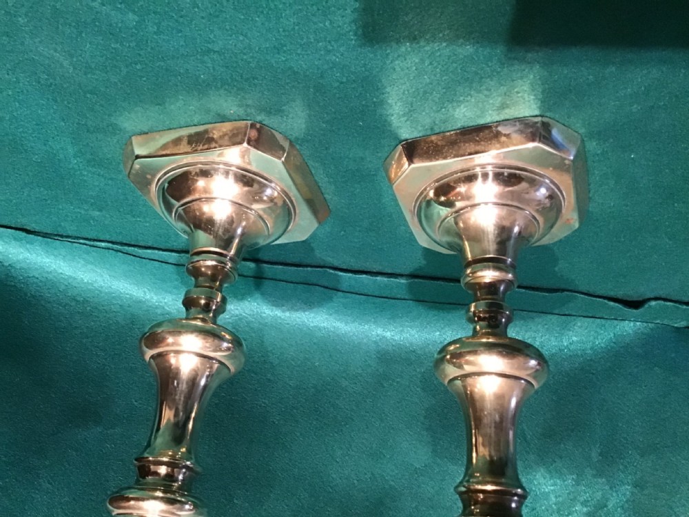 A pair of antique candlesticks View II