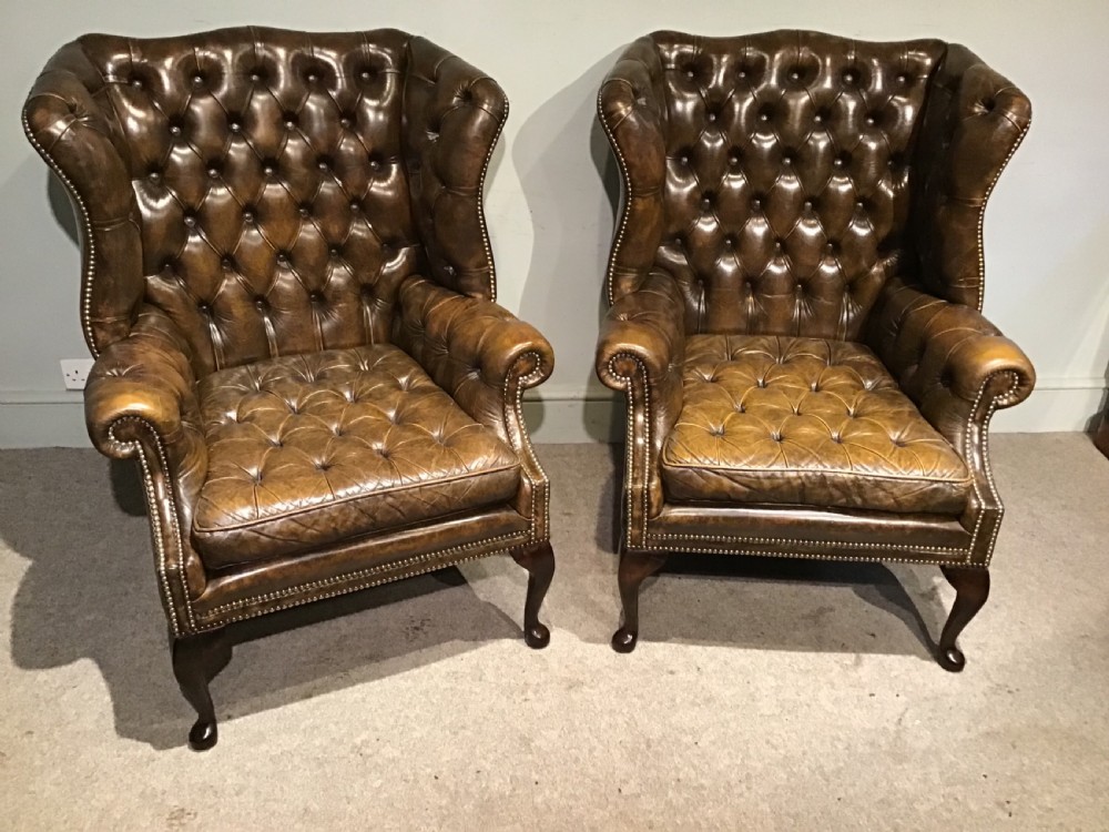 Pair of leather upholstered wing chairs View II