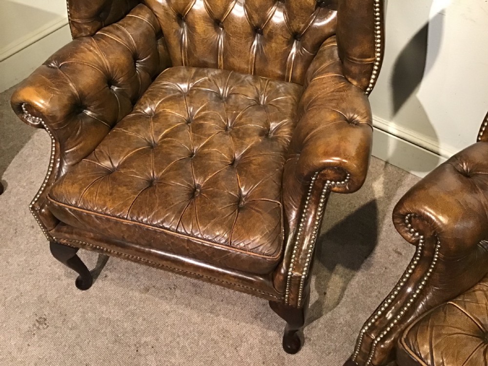 Pair of leather upholstered wing chairs View V