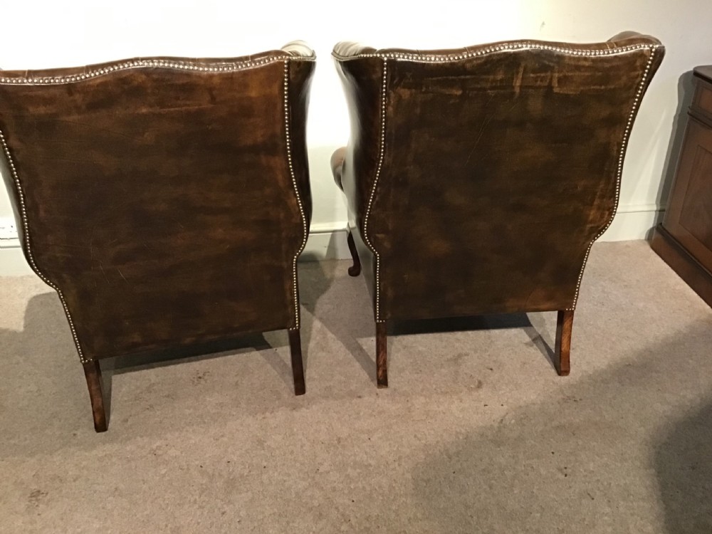 Pair of leather upholstered wing chairs View X
