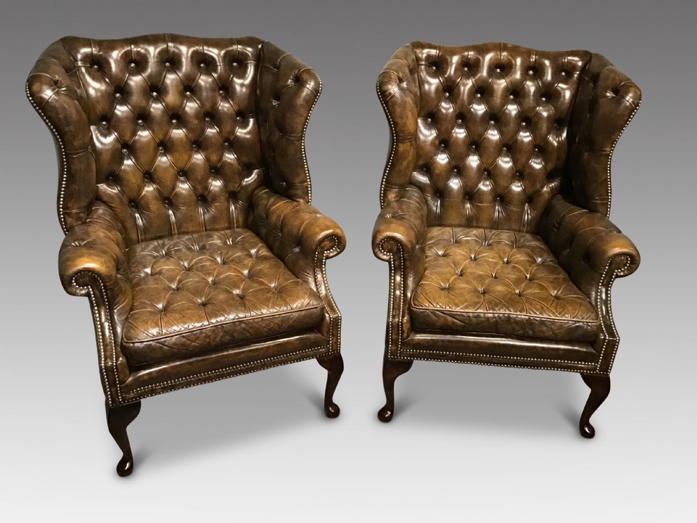 Pair of leather upholstered wing chairs