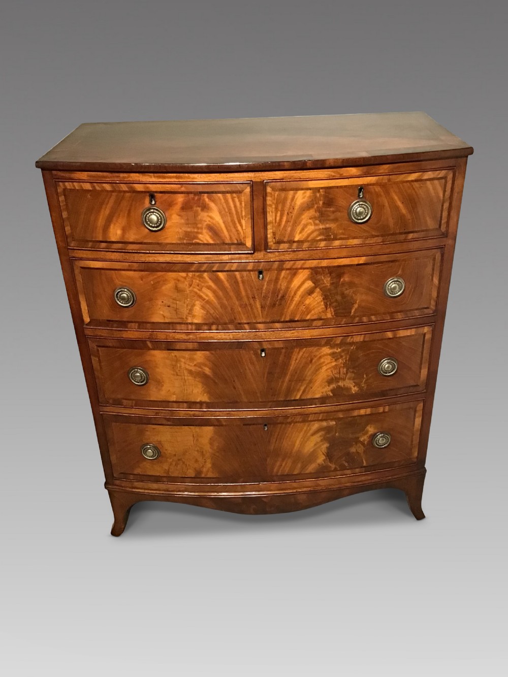 Antique bow front chest of drawers