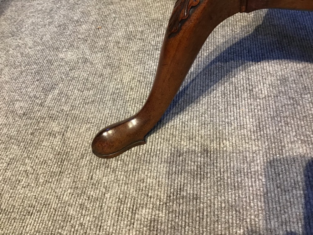 An antique Georgian mahogany tripod washstand featuring an upper basin ring, a middle triangular drawer section with an urn finial, and cabriole legs. View VI