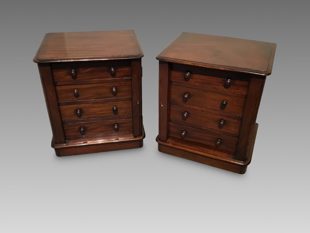 A pair of antique mahogany miniature Wellington chests