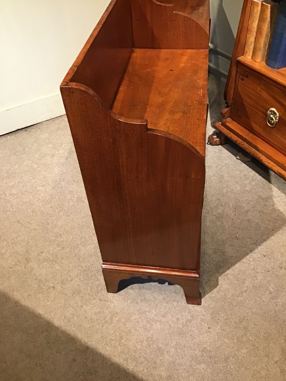 An antique mahogany side cabinet featuring a two-section top gallery, four panelled doors, and standing on bracket feet. View X