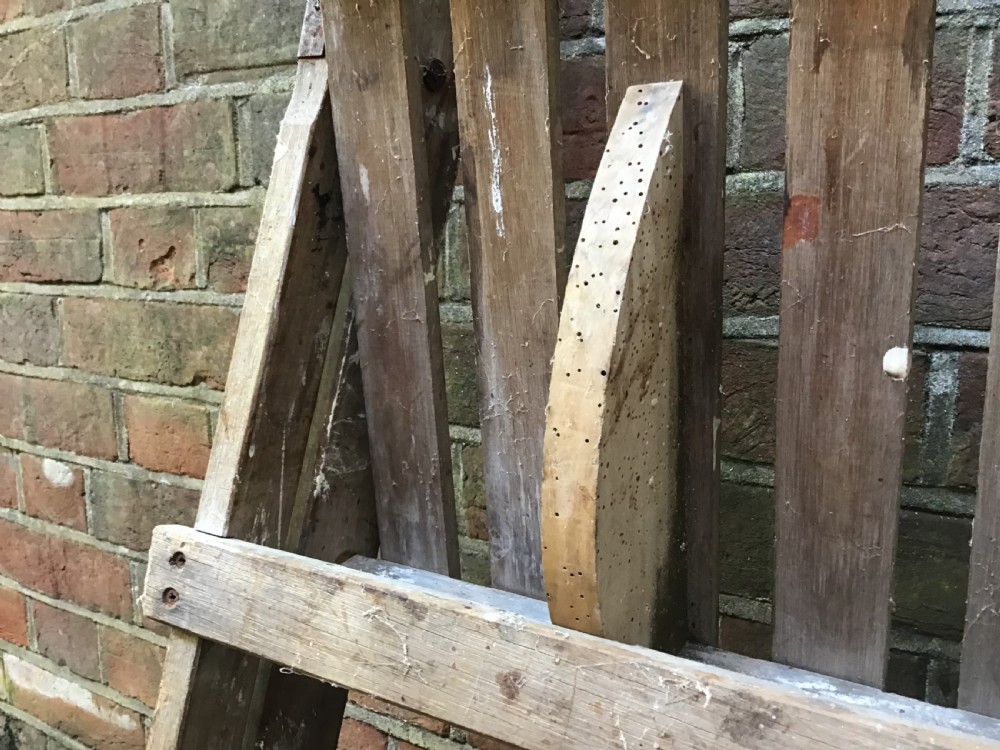 A tall weathered wooden A-frame stepladder featuring a slatted top platform and multiple flat treads. View XI