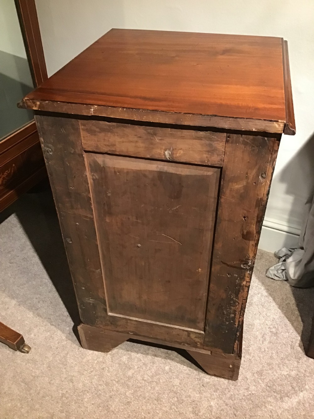 A narrow Georgian-style warm brown mahogany chest of drawers featuring four graduated drawers with pierced brass handles, a brushing slide, and bracket feet. View VIII