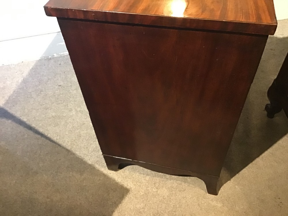 An antique mahogany chest of drawers featuring three drawers with brass oval handles and bracket feet. View VIII