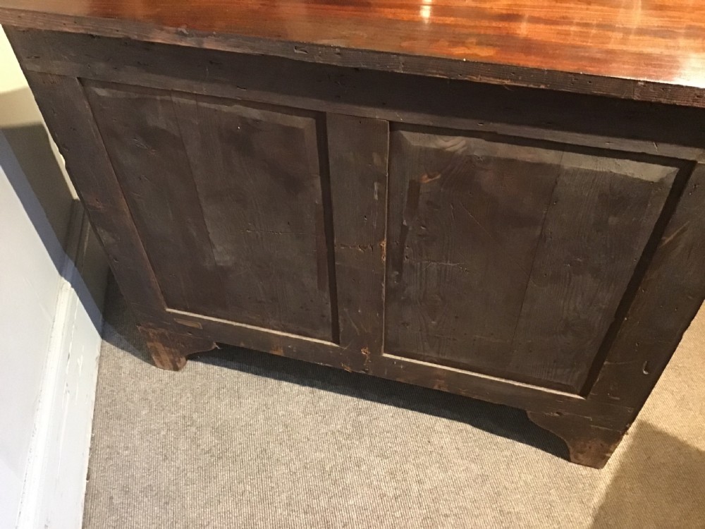 An antique mahogany chest of drawers featuring three drawers with brass oval handles and bracket feet. View IX