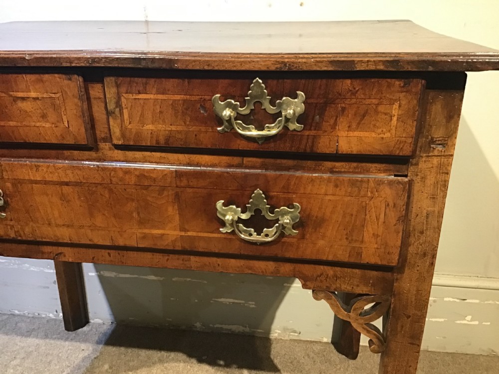 An 18th-century style antique walnut lowboy table featuring three drawers with decorative brass handles and fretwork corner brackets. View IV