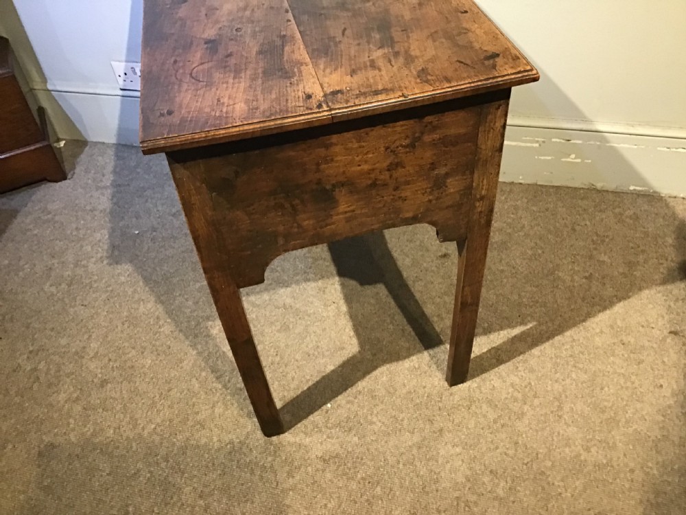 An 18th-century style antique walnut lowboy table featuring three drawers with decorative brass handles and fretwork corner brackets. View VIII