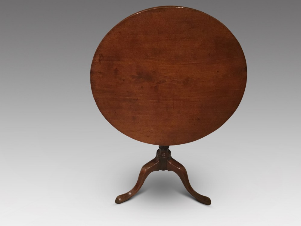 A Georgian mahogany tripod table featuring a smooth circular top supported by a turned central pedestal and three cabriole legs. View II