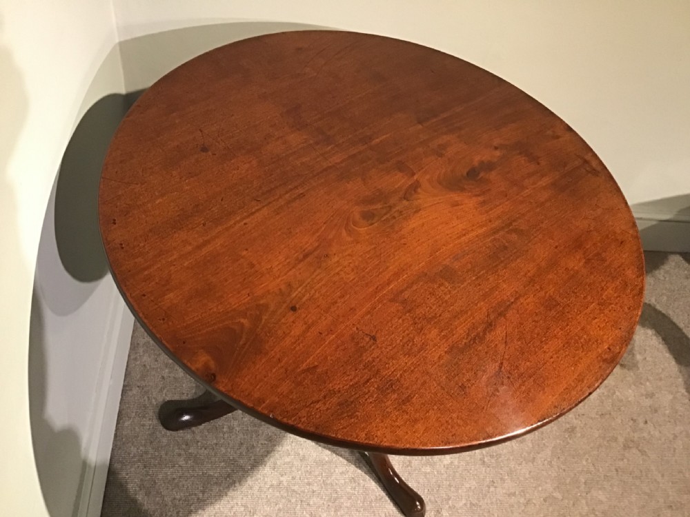 A Georgian mahogany tripod table featuring a smooth circular top supported by a turned central pedestal and three cabriole legs. View IV