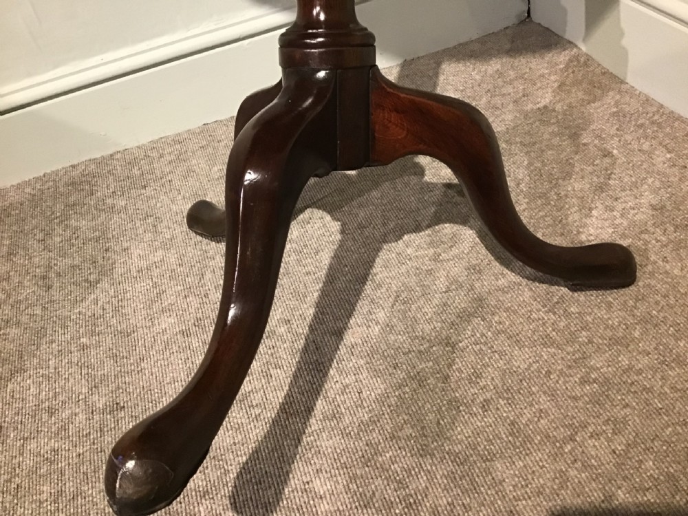 A Georgian mahogany tripod table featuring a smooth circular top supported by a turned central pedestal and three cabriole legs. View V