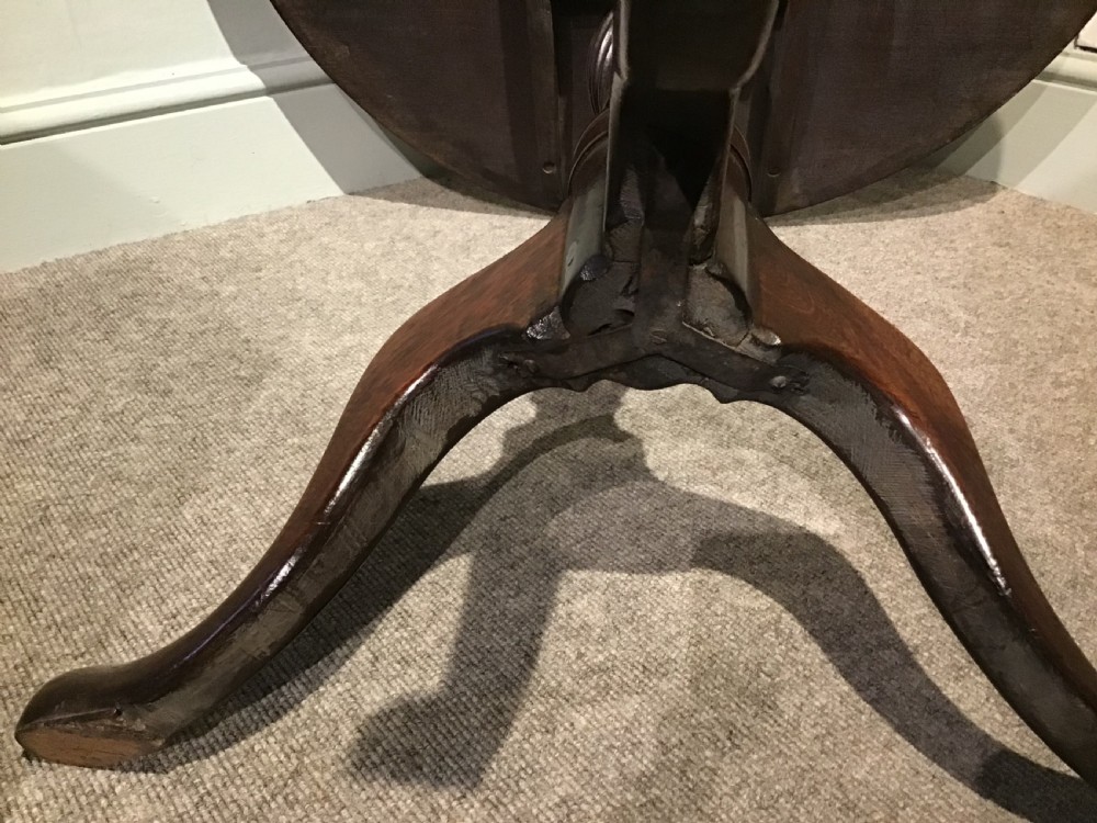 A Georgian mahogany tripod table featuring a smooth circular top supported by a turned central pedestal and three cabriole legs. View VI