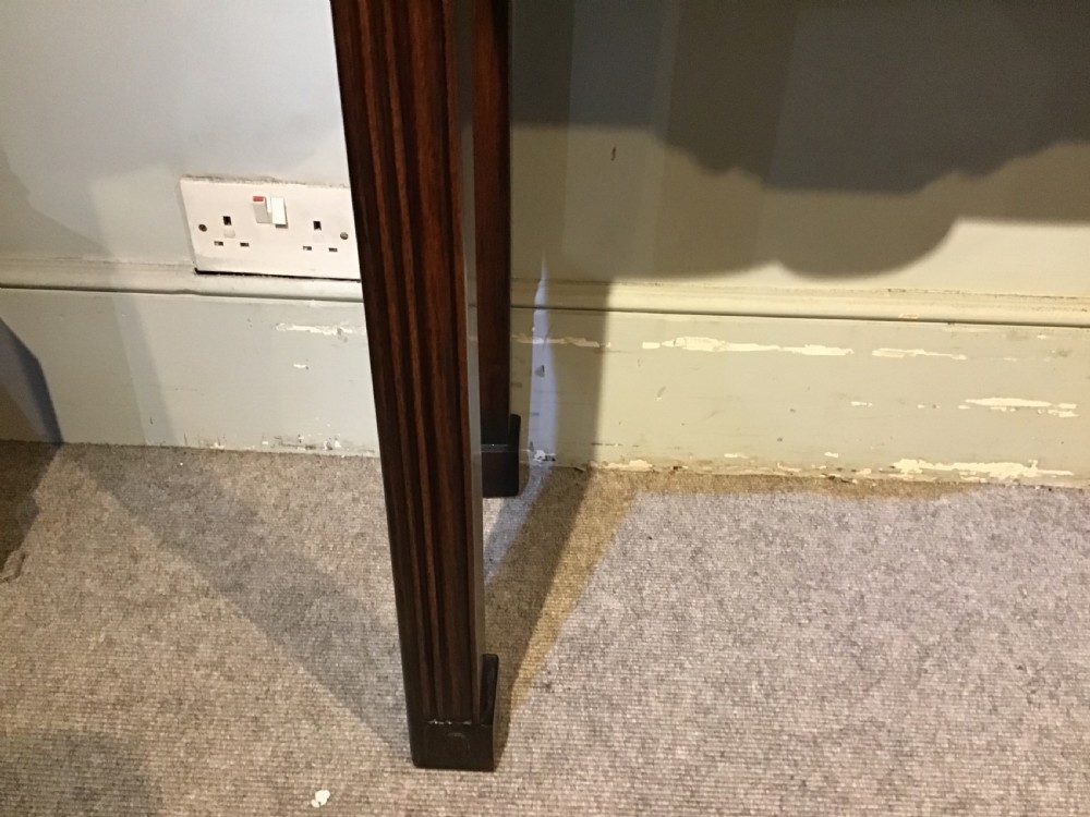 A narrow dark brown timber Chinese altar table featuring carved corner spandrels, reeded square legs, and a rectangular panelled top. View VI