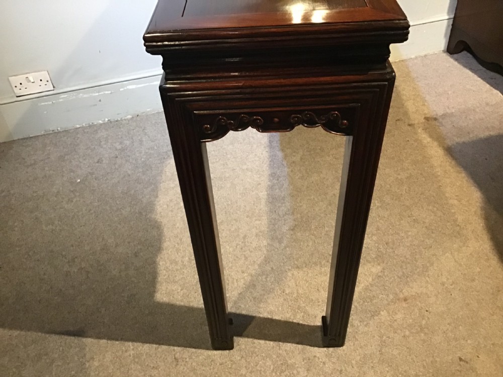A narrow dark brown timber Chinese altar table featuring carved corner spandrels, reeded square legs, and a rectangular panelled top. View XII