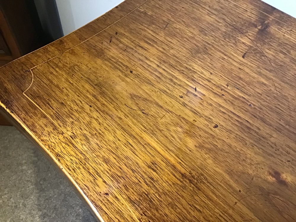 A Georgian style mahogany sideboard featuring a serpentine front, inlaid oval motifs on tapered legs, and brass handles. View XI